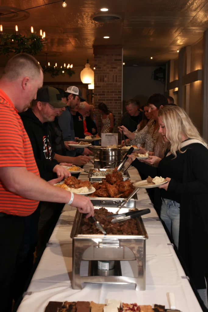 A family grabbing food from buffet